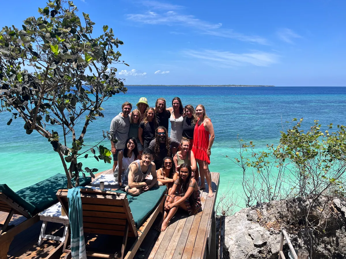 The wooden jetty at Tevana House Reef reaching out over turquoise water in Bira