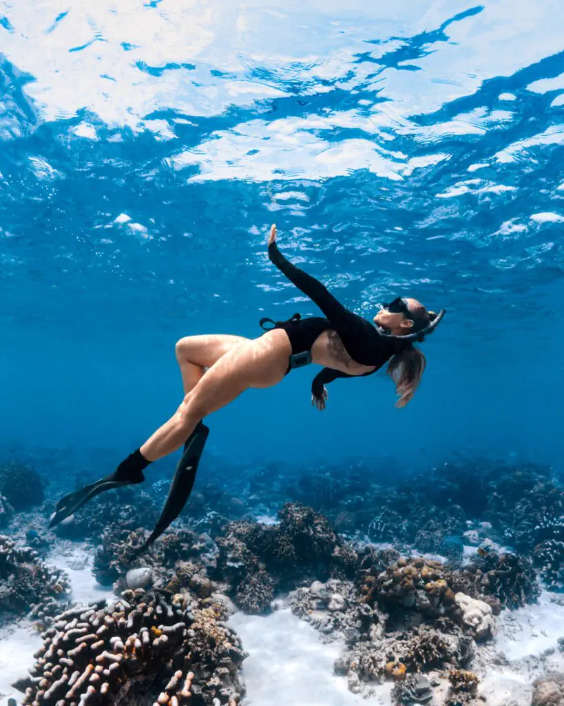 Freediver exploring the reef wall in Bira