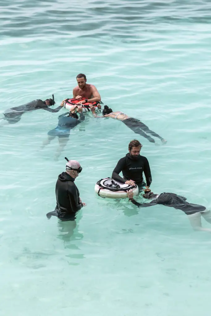 Freediver suspended in open water above the reef