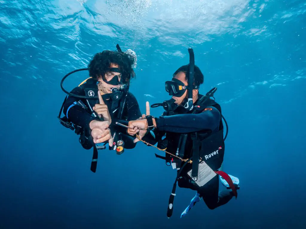 Student diver underwater with an instructor on a rescue dive course in Bira, South Sulawesi